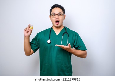 Surprised Asian Male Nurse Or Doctor Pointing And Showing Urine Pot Sample Isolated Over White Background