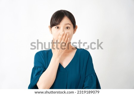 Surprised Asian middle aged woman in white background round