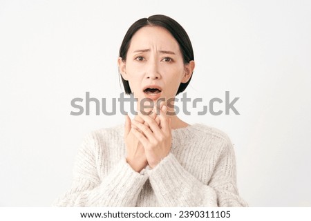 Surprised Asian middle aged woman in white background