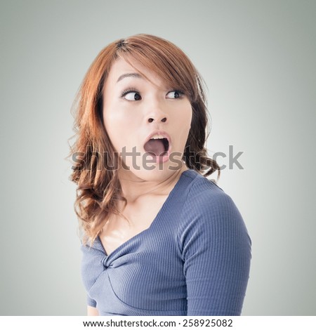 Surprised Asian woman, closeup portrait.