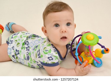 Surprised Baby Holds Toy Lying On Stock Photo 1257207124 | Shutterstock