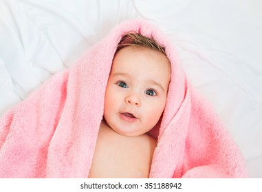 Surprised Baby With A  Pink Towel After The Shower