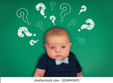 Surprised Baby With Question Marks On Background