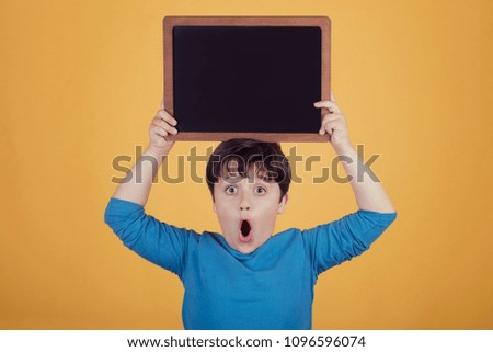 surprised boy with a blackboard