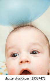 Surprised Child, And Hair From A Static Electricity Reach For A Balloon