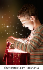 A Surprised Child Opening And Looking Inside A Magic Gift