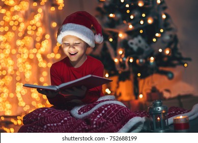 Surprised Child Opening Magic Christmas Book. Xmas Holiday Concept