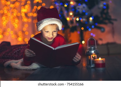 Surprised Child Opening Magic Christmas Book. Xmas Holiday Concept