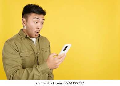 Surprised chinese man looking the screen of a mobile - Powered by Shutterstock