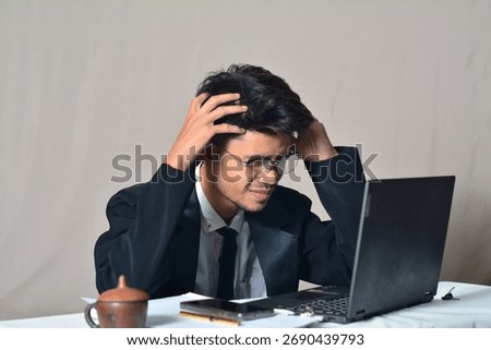A surprised or disbelieving expression, seeing something unexpected on the laptop screen.