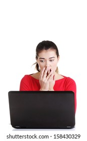 Surprised and disgusted woman working on laptop. Isolated on white. 