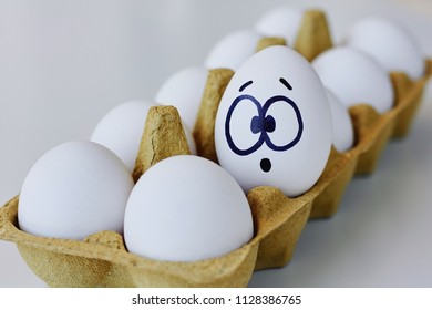 Surprised egg in a brown carton box, emoticons concept - Powered by Shutterstock