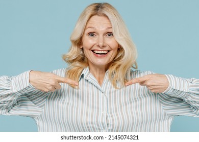 Surprised Elderly Smiling Exultant Caucasian Woman 50s Wearing Casual Striped Shirt Point Index Finger On Herself Isolated On Plain Pastel Light Blue Color Background Studio. People Lifestyle Concept