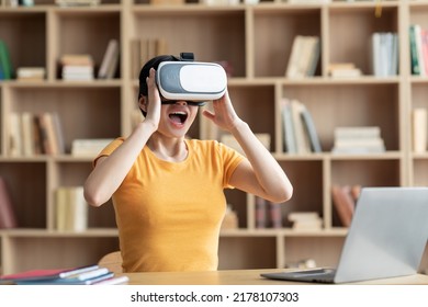 Surprised Excited Young Chinese Lady In Vr Glasses Playing Online Games, Exploring Augmented World In Room Interior. Digital Devices For Entertainment At Home, Virtual Reality Due Covid-19 Outbreak