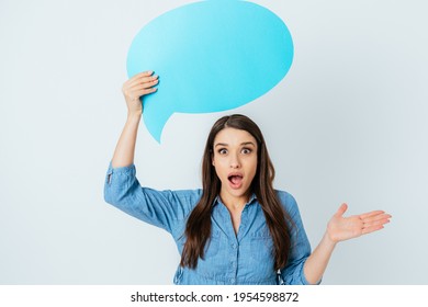 Surprised Excited Young Woman Holding Chat Bubble Above Her Head With Blank Space For Text While Standing On White Studio Background