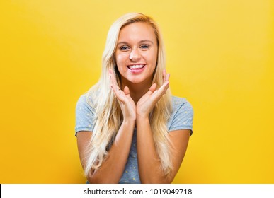 Surprised And Excited Young Woman Posing On A Solid Background