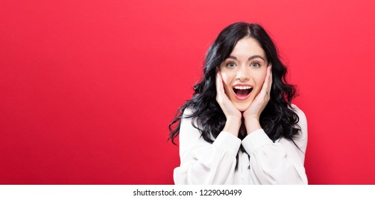 Surprised And Excited Young Woman Posing On A Solid Background