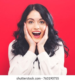 Surprised And Excited Young Woman Posing On A Solid Background