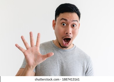 Surprised face Asian man making number hand sign on isolated white background. - Shutterstock ID 1887413161