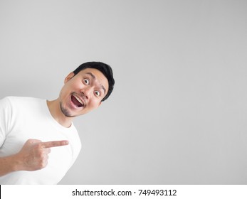 Surprised face of happy asian man in white shirt  light grey background.