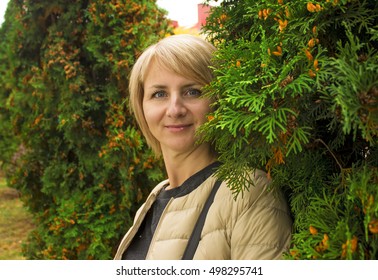 Surprised girl with big eyes near the green trees. Portrait. There is a model release. - Shutterstock ID 498295741