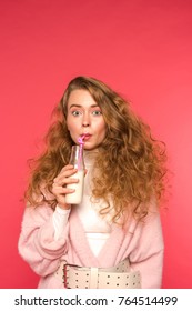 Surprised Girl Drinking Milkshake With Plastic Straw Isolated On Red