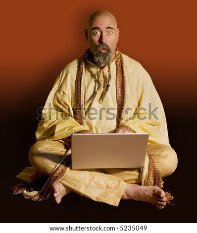 Surprised guru with a laptop computer.