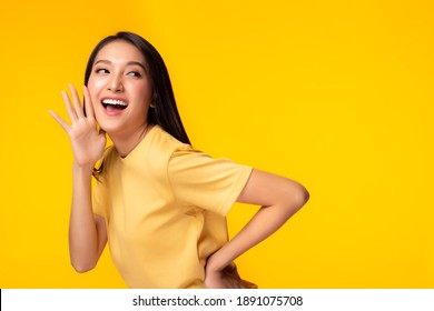 Surprised Happy Beauty Asian Woman Looking Copy Space In Excitement Expressive Facial Expressions Presenting Some Product. Beautiful Girl Act Like A Telling Secret Isolated On Yellow Background