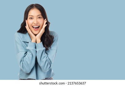 Surprised Happy Beauty Asian Woman Looking Camera In Excitement Expressive Facial Expressions Presenting A Product Beautiful Girl Act Like A Telling Something Isolated On Light Blue Background