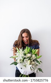 Surprised And Happy Caucasian Young Girl Receiving Bouquet Of Flowers. Surprise Valentine's Or Anniversary Gift