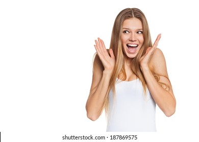 Surprised happy young woman looking sideways in excitement. Isolated over white background