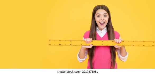 Surprised Kid Girl Use Ruler To Learn Mathematics, Measurement. Banner Of School Girl Student. Schoolgirl Pupil Portrait With Copy Space.