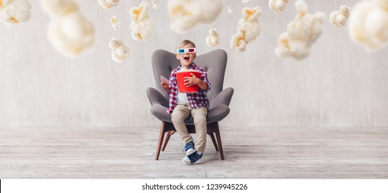 Surprised kid with popcorn in 3d glasses in the cinema - Powered by Shutterstock