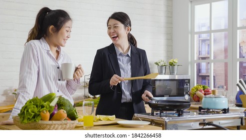 Surprised Lazy Girl Roommate In Nightwear Watching Office Lady Successfully Playing And Flipping Egg In Hot Pan.