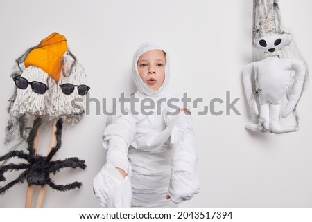 Similar – Foto Bild Happy Halloween.überrascht Kind in einem Skelett-Kostüm mit Popcorn gegen orange Hintergrund