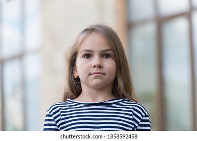 Surprised Little Kid With Long Hair In Stripy Top Keep Eyes Wide Open Outdoors, Surprise.