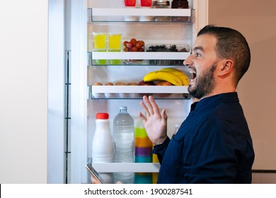 Surprised Man Looking Inside The Fridge