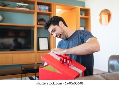 Surprised Man Opening A Gift Box.