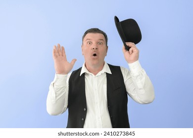 Surprised man in a retro suit. Bowler hat, white shirt and black vest. Light blue background. - Powered by Shutterstock