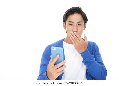 Surprised man with smart phone - Shutterstock ID 2242800351