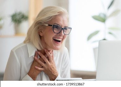 Surprised middle-aged businesswoman in glasses feel shocked read unexpected news online on laptop, stunned senior female employee feel amazed excited with pleasant email or message on computer