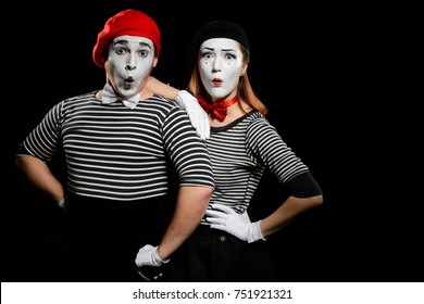 Surprised Mimes, Isolated On Black. Couple Of Male And Female Actors Expressing Different Emotions During A Pantomime Show.