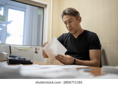 Surprised office worker reading document with an open mouth. Unexpected news, shock, or surprising business letter.