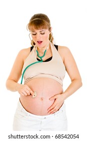 Surprised Pregnant Woman Holding Stethascope On Her Belly Isolated On White