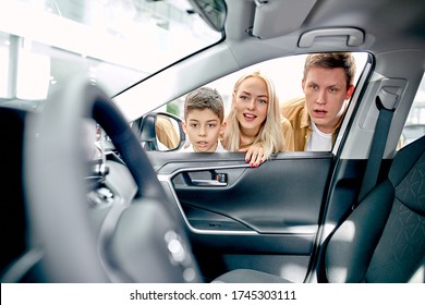 Surprised Shocked Caucasian Family Look Inside Of Car, Stay In Shock. Look! How It Is Comfortable And Fast!