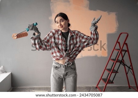 Surprised shocked female painter with roller. Redecoration, renovation, apartment repair concept. [[stock_photo]] © 