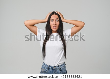 Surprised shocked impressed crying young caucasian woman girl shouting, feeling scared terrible horrible, fear isolated in grey background. Sale discount offer concept. Bad sad news