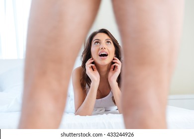 Surprised Shocked Woman Lying In A Bed Looking Scared To Men's Genital