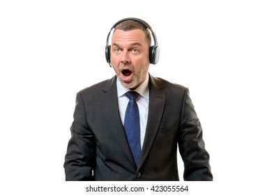 Surprised Sportscaster With Mouth Wide Open Wearing Business Suit And Headset Against A White Background