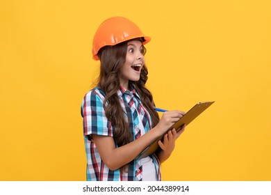 Surprised Teen Girl In Construction Helmet Making Notes In Clipboard, Check Results